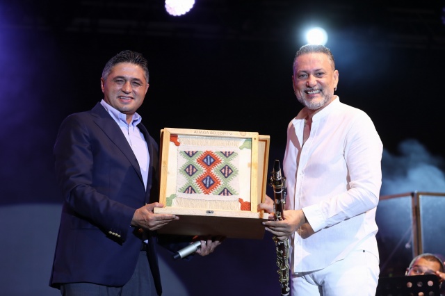 Başkan Serkan Acar’dan Sanatçılara ve Aliağalılara Teşekkür
Konserin bir bölümünde sahneye davet edilen Aliağa Belediye Başkanı Serkan Acar, ünlü sanatçılara Aliağa Sanat Günleri’ne katılımlarından dolayı kendilerine Aliağalı üretici kadınlar tarafından el emeği ile üretilen, Aliağa yöresine özgü, tarihi Helvacı Kilimi hediye etti. Başkan Serkan Acar, “Hayranlıkla dinlediğimiz sanatçıları Aliağamızda ağırlamaktan büyük mutluluk duyuyoruz. Sanatçılarımıza, sanat günlerimize katılımlarından dolayı teşekkür ediyorum. En büyük teşekkürü ise sanata ve sanatçıya her daim sahip çıkan çok değerli Aliağa halkımıza ediyorum” dedi.